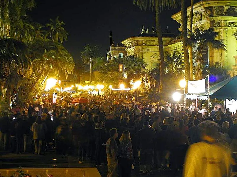 Crowds under the lights in Balboa Park at night