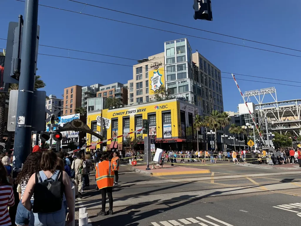 Busy downtown San Diego intersection with a trolley line