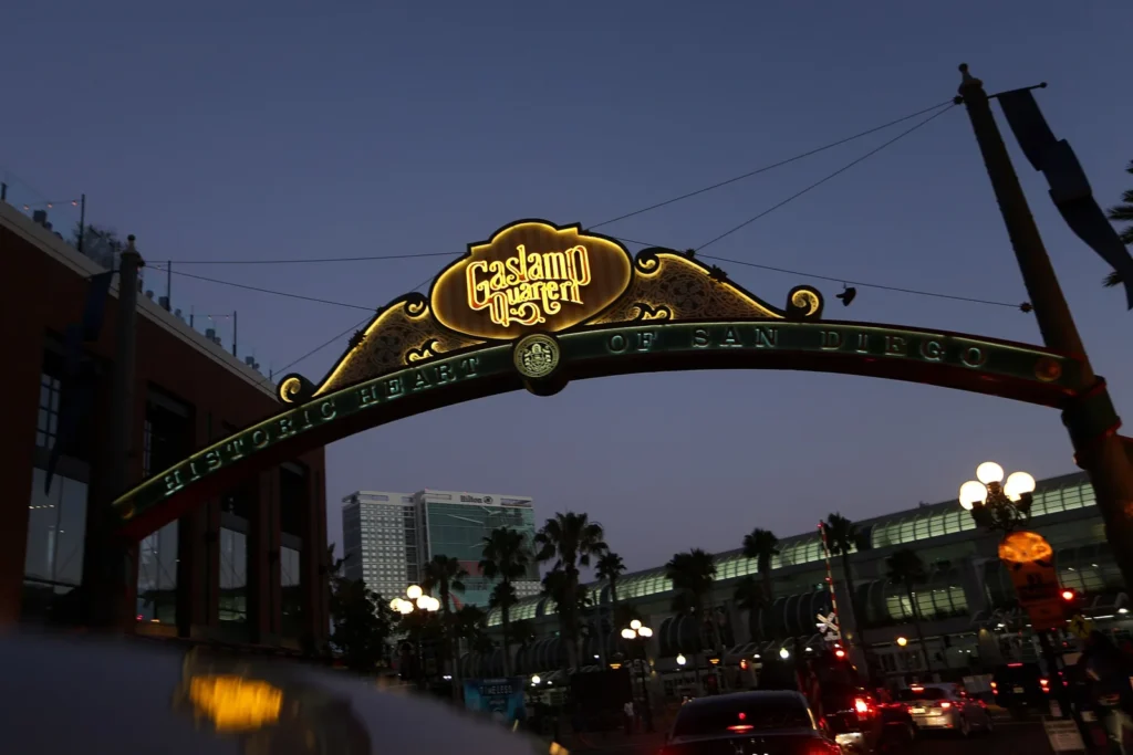 The lighted Gaslamp Quarter arch sign at dusk in downtown San Diego