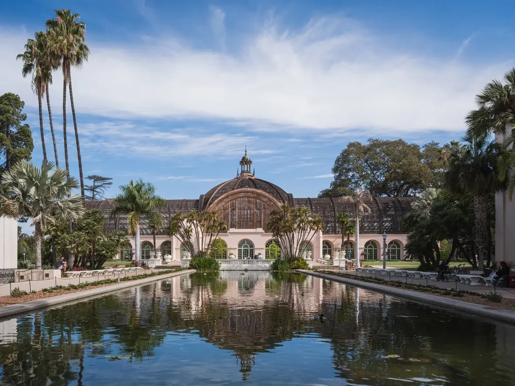 Lily pond and Botanical Building framed by palms in Balboa Park