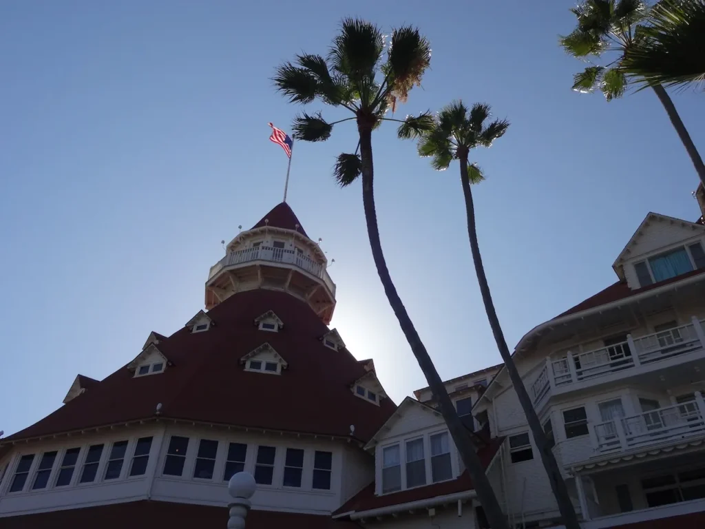 Red turrets of the Hotel del Coronado framed by palms