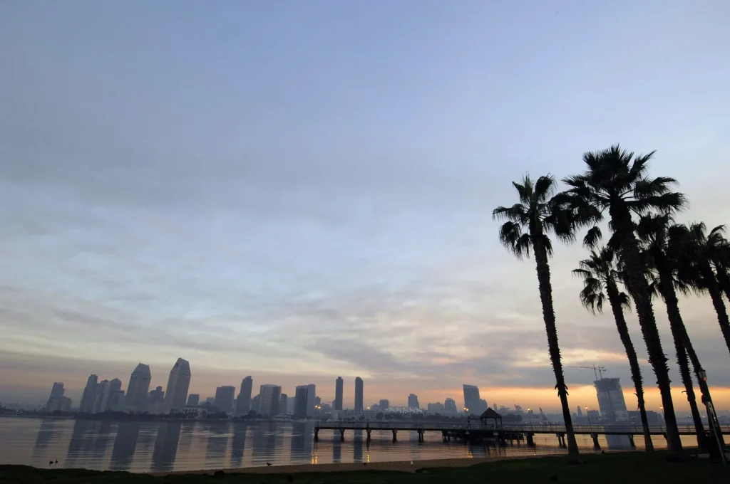 Sunrise over Downtown San Diego and the Coronado ferry landing under low fog
